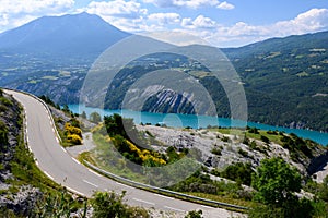 View on blue Lake of Serre-Poncon, reservoirÂ border betweenÂ Hautes-andÂ Alpes-de-Haute ProvenceÂ departments, one of